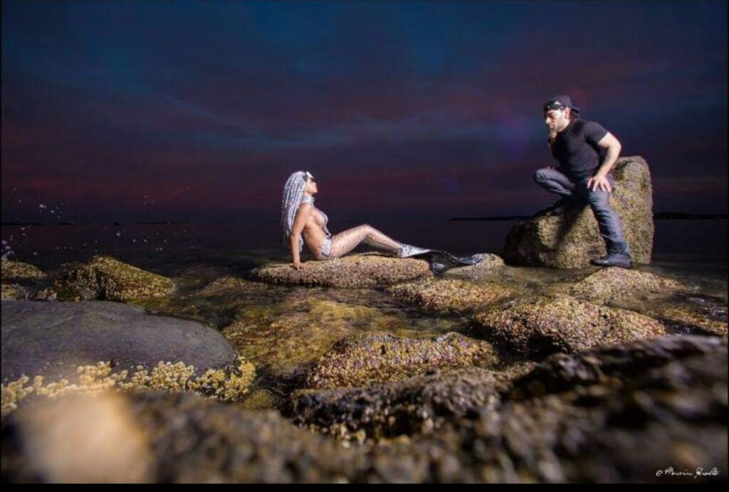 Model Doing Posing in a Rock with Stylist